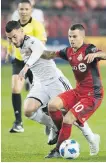  ?? CP ?? Toronto FC forward Sebastian Giovinco, right, battles for the ball against Vancouver Whitecaps’ Russell Teibert during second-half MLS action in Toronto.