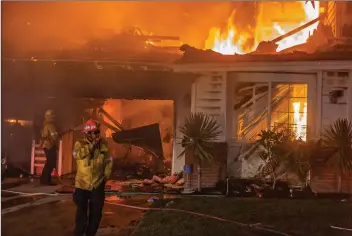  ?? Cory Rubin/The Signal ?? A house on the 29500 block of Sequoia Road in Canyon Country burns early Friday during the Tick Fire.