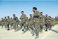  ?? FILE PHOTO] ?? Newly graduated Afghan National Army soldiers march during their graduation ceremony Jan. 21 at the Afghan Military Academy in Kabul, Afghanista­n. [ASSOCIATED PRESS