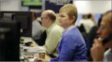  ?? MARK LENNIHAN — THE ASSOCIATED PRESS ?? In this photo, traders work on the Mizuho Americas trading floor in New York. Global stocks traded in narrow ranges Thursday as investors nervously awaited the first meeting between President Donald Trump and his Chinese counterpar­t, Xi Jinping, a day...