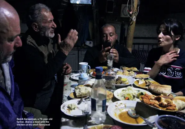  ?? JACK LOSH ?? Romik Karapetyan, a 73-year-old farmer, shares a meal with the trackers at his small farmstead