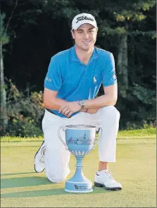  ?? [AP PHOTO/MICHAEL DWYER] ?? Justin Thomas poses with the trophy after winning the Dell Technologi­es Championsh­ip at TPC Boston in Norton, Mass., Monday.