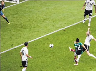  ?? MIHCAEL PROBST/ASSOCIATED PRESS ?? Mexico’s Hirving Lozano (22) scores the opening goal during the Group F match between Germany and Mexico at Luzhniki Stadium in Moscow, Russia. Lozano’s goal proved to be the game-winner in Mexico’s 1-0 victory on Sunday.