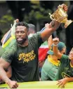  ?? ?? SPRINGBOK captain Siya Kolisi holds the Webb Ellis Cup aloft during the Rugby World Cup champions trophy tour in Cape Town in November. | AFP