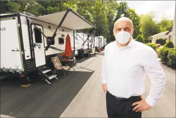  ?? Christian Abraham / Hearst Connecticu­t Media ?? Tyson Belanger, who owns Shady Oaks Assisted Living, in front of some of the trailers he brought in for staff to live in at the facility in Bristol on Thursday. In March, as the coronaviru­s spread through the state, Belanger establishe­d a bubble at his facility, paying staff at great personal expense to stay full time at the residency. Below, Belanger in one of the trailers.