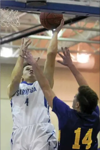  ?? DAVID M. JOHNSON - DJOHNSON@DIGITALFIR­STMEDIA.COM ?? Saratoga Springs’ Brian Hart lays it in as CBA’s Justin Caulfield defends during a Suburban Council boys basketball game Dec. 5, 2017 at Saratoga Springs High School.