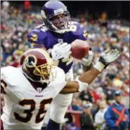  ?? EVAN VUCCI — THE ASSOCIATED PRESS FILE ?? This 2005 photo shows Vikings wide receiver Randy Moss catching a touchdown pass over Redskins safety Sean Taylor in Landover, Md.