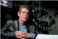  ?? IL — JIM COOPER ?? This file photo shows Anthony Bourdain, the owner and chef of Les Halles restaurant, sitting at one of the tables in New York. On Friday Bourdain was found dead in his hotel room in France, while working on his CNN series on culinary traditions around...