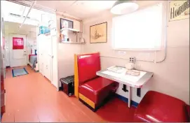  ?? Centre Daily Times ?? A seating area, bathroom and shower and two single beds are in the 1941 caboose at the Castanea Railroad Station that visitors can stay in.