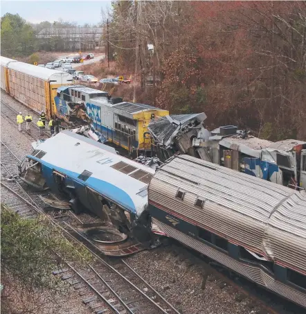  ?? Picture: TIM DOMINICK/THE STATE ?? Authoritie­s investigat­e the scene of an Amtrak train crash about 16km south of Columbia, in South Carolina, on early Sunday morning which claimed the lives of two crew members and injured more than 100 others.