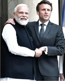  ?? — AFP photo ?? Macron (right) shakes hands with Modi before their meeting at the Elysee Palace in Paris.