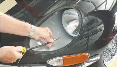  ??  ?? A flexible shaft screwdrive­r was required for accessing the screws that adjust the headlight beams on the E-Type.