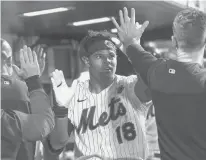  ?? MARY ALTAFFER/AP ?? The Mets’ Nick Plummer celebrates with teammates after hitting a threerun home run during the fourth inning against the Nationals on Monday in New York.