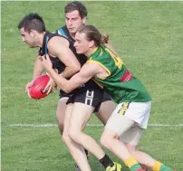  ??  ?? Yarragon’s Chris Karlis is met by a strong Hill End tackle; Photograph­s: Paul Cohen.