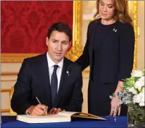  ?? ?? TRIbUTeS: Canadian PM Justin Trudeau and wife Sophie and, right, Belize’s Dame Froyla Tzalam sign condolence book