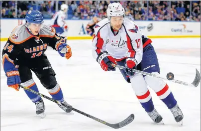  ?? AP PHOTO ?? Washington Capitals’r Wojtek Wolski tries to control the puck as he skates around New York Islanders’ Thomas Hickey during an NHL game at Nassau Coliseum in Uniondale, N.Y., Saturday, March 9, 2013. Wolski is among the former NHL veterans named to...