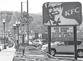  ?? THE-DAILY-RECORD.COM MIKE SCHENK ?? Now-hiring signs at fast food places on Beall Avenue.