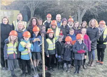  ??  ?? Growing strong Torphichen Primary ‘s pupils show off their new orchard