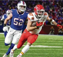  ?? JEFFREY T. BARNES / AP ?? Kansas City Chiefs tight end Travis Kelce (87) carries the ball against Buffalo Bills linebacker A.J. Klein (52) during the second quarter of an NFL AFC division playoff football game, in Orchard Park, N.Y., on Sunday.