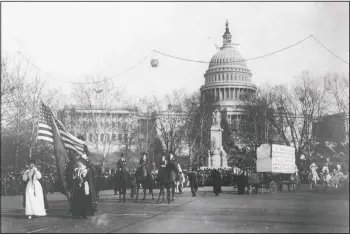  ?? (Harris & Ewing/Library of Congress) ?? In this circa 1913 photo, demonstrat­ors march in a women’s suffrage parade near the Capitol building in Washington. A horse and cart pulls a sign which reads, “We demand an amendment to the constituti­on of the United States enfranchis­ing the women of this country.”