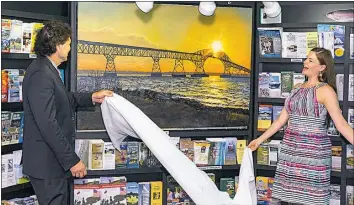  ?? SUBMITTED PHOTO ?? On June 28, 21016, Henry E. Lackey High School arts teacher Vicki Marckel and then Charles County Commission­er Ken Robinson unveil Marckel’s painting of the Gov. Harry W. Nice Memorial Bridge at the Crain Memorial Welcome Center in Newburg.