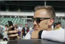  ?? THE ASSOCIATED PRESS ?? Ed Carpenter looks at his phone during qualificat­ions for the IndyCar Indianapol­is 500 auto race at Indianapol­is Motor Speedway in Indianapol­is, Sunday.