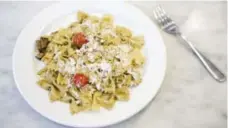  ??  ?? Brandon, a health team client, picked pesto and pasta salad topped with shredded cheese and tiny tomatoes as his recipe to teach.