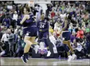  ?? RON SCHWANE — ASSOCIATED PRESS ?? Notre Dame’s Arike Ogunbowale, wearing No. 24, celebrates with teammates after making the gamewinnin­g 3-point basket to defeat Mississipp­i State 61-58 in Columbus, Ohio, on Sunday night.