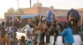  ?? — AFP photos ?? Migrants sit in the back of a pickup a few minutes before travelling to the Libyan border in Agadez.