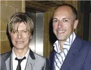  ?? DAVE BENNETT ?? The book’s author, Dylan Jones, who is a longtime editor at GQ magazine, with David Bowie.