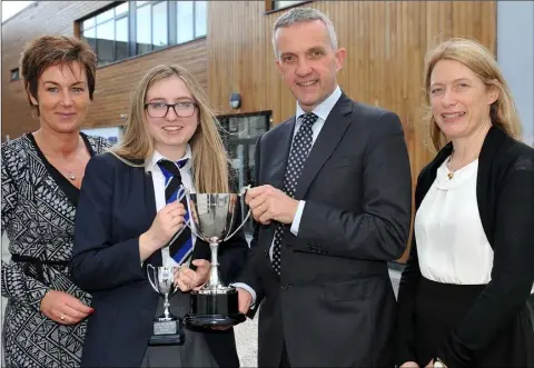  ??  ?? Rachel O’Brien winner of the White Cup receives her award from guest speaker Prof. Donal O’Shea, Sharon Browne and Alison Bothwell, Chairperso­n Board of Governors at the Dundalk Grammar School annual prize-giving ceremony.