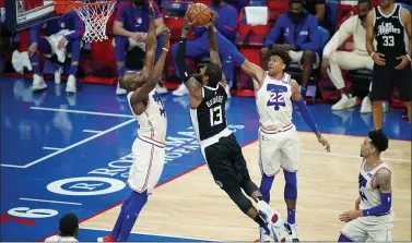  ?? MATT SLOCUM - THE ASSOCIATED PRESS ?? Matisse Thybulle, right, and Anthony Tolliver, right, try to block a shot by the Clippers’ Paul George, center, Friday night at the Wells Fargo Center. Thybulle’s offense is slowly catching up with his defense.