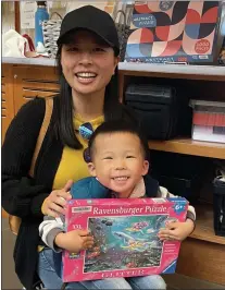  ?? PHOTO BY DEBBY RICE ?? Peace Cheung and son Elijah check out puzzles at the
Los Gatos Library. “We are home to home to hundreds of community workshops, books, puzzles, digital resources and other materials you can access for free,” says Jennifer Laredo, division manager and teen librarian.