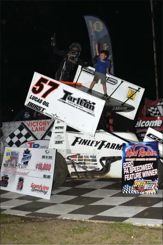  ?? RICH KEPNER - FOR MEDIANEWS GROUP ?? Kyle Larson, left, and his son Owen stand atop his sprint car after winning the Hodnett Cup race at Grandview Speedway Tuesday night.