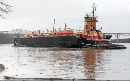  ?? PHILIP KAMRASS — OFFICE OF NEW YORK GOV. ANDREW CUOMO ?? The barge that ran aground Tuesday sits near the west shore of the Hudson River at Catskill, N.Y., with the Rip Van Winkle Bridge in the background.