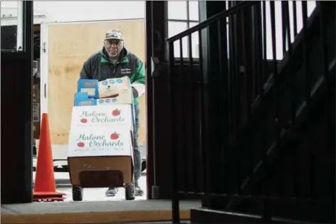  ?? ERIC BONZAR — THE MORNING JOURNAL ?? Clarence Ballard, 77, of Lorain unloads boxes of perishable and non-perishable food at Greater Victory Christian Ministries Church, 559 Reid Ave., Feb. 16.