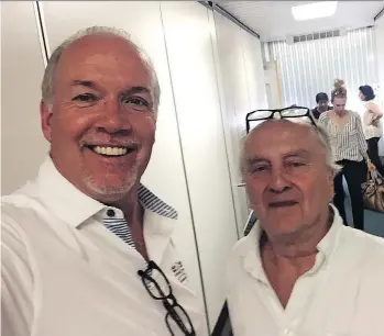  ??  ?? B.C. Premier John Horgan and Postmedia reporter Larry Pynn take an airport terminal selfie.