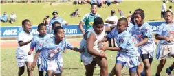  ??  ?? Suva Blue player on the attack against Suva White during the U9 final during the Kaji rugby tournament at the ANZ Stadium in Suva. Photo: Ivamere Rokovesa.
