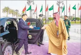  ?? Saudi Press Agency ?? SAUDI CROWN PRINCE Mohammed bin Salman, right, greets Chinese President Xi Jinping after Xi’s arrival at Yamama Palace in Riyadh on Dec. 8.