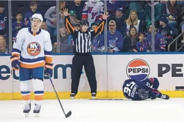  ?? GETTY ?? Ryan Lindgren writhes in pain after getting tangled with Jean-Gabriel Pageau and does not return to game.