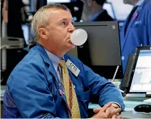  ?? AP ?? Has the bubble burst? Trader James Lamb watches his screens on the floor of the New York Stock Exchange.