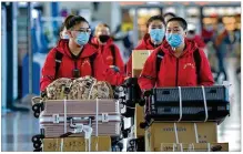  ?? LIU LEI / XINHUA / ZUMA PRESS ?? Medical team members check in at Hohhot Baita Internatio­nal Airport before leaving for Hubei Province in Hohhot, capital of China’s Inner Mongolia Autonomous Region.