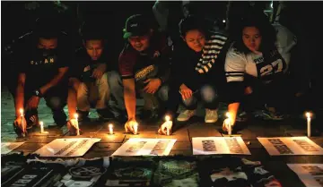  ??  ?? Football supporters from East Java hold a vigil for victims of the suicide bomb attacks in Surabaya at a city park in Jakarta— Reuters photo