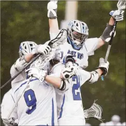  ?? Dave Stewart / Hearst Connecticu­t Media ?? Darien players celebrate after a goal against Staples in the FCIAC final on May 28.