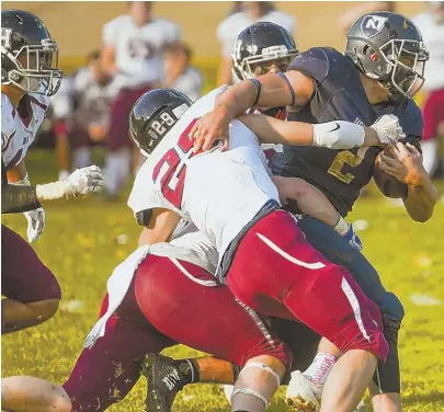  ?? HERALD PHOTOS BY JEFF PORTER ?? STRONG ON ALL SIDES: Above, Nobles sophomore Casey Phinney is pulled down by Belmont HIll’s defense yesterday in Dedham. At right, Greg Desrosiers breaks out on a punt return for one of his two touchdowns in his team’s dominant victory.