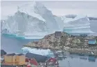  ??  ?? The iceberg drifting toward the village in Greenland.