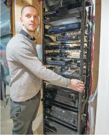  ??  ?? Rolland Dean Winters of Homesync displays the audio, video, internet, cable and security recording equipment at Ghassan Cordahi’s home.