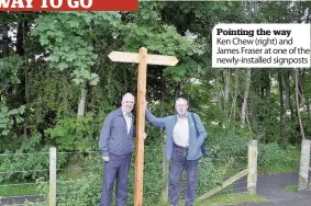  ??  ?? Pointing the way Ken Chew (right) and James Fraser at one of the newly-installed signposts