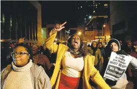  ?? ROB CARR/GETTY IMAGES PHOTOS ?? Protesters march through the streets of Baltimore on Wednesday after a mistrial was declared in the trial of Baltimore police Officer William G. Porter. The judge declared a mistrial on the third day of deliberati­ons in Porter's trial.