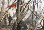  ?? Sergey Ponomarev / Associated Press 2010 ?? Police officers walk at the site of the plane crash in Russia that killed Polish President Lech Kaczynski.